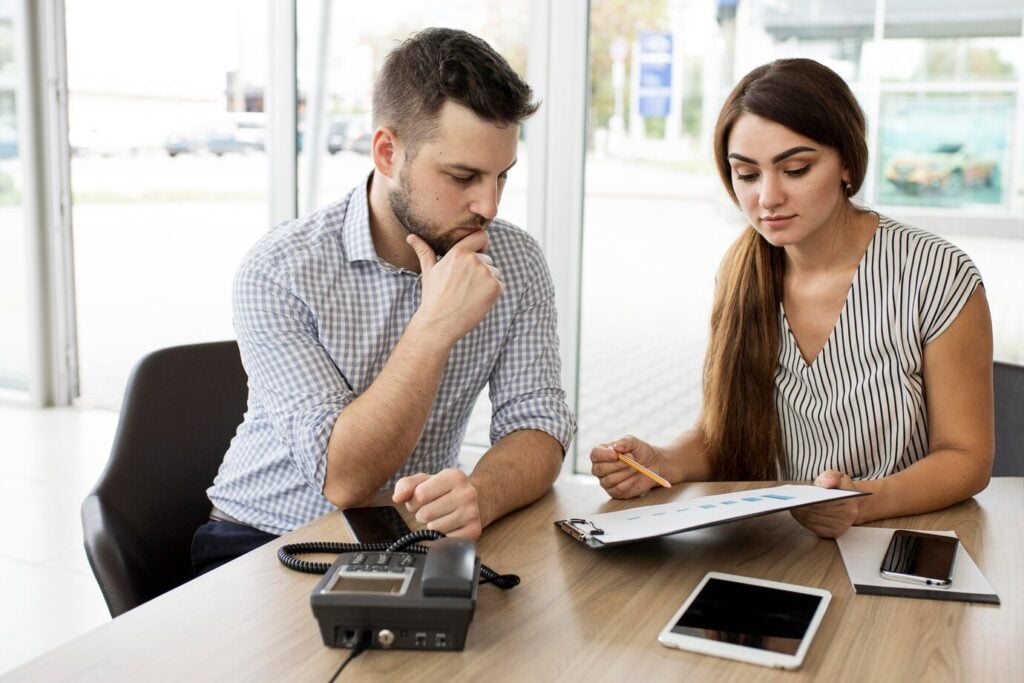 A imagem mostra um exemplo de duas pessoas discutindo a melhor escolha para ser feita sobre uma carta de crédito.