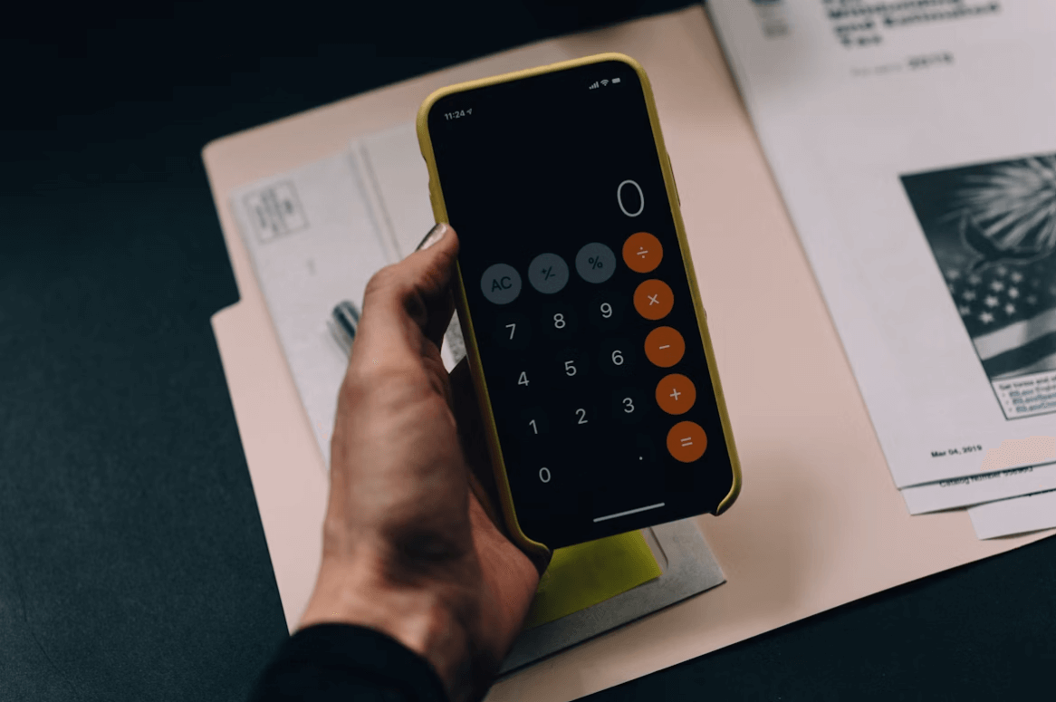 Pessoa calculando quanto de desconto ele terá utilizando sua carta contemplada como moeda de troca